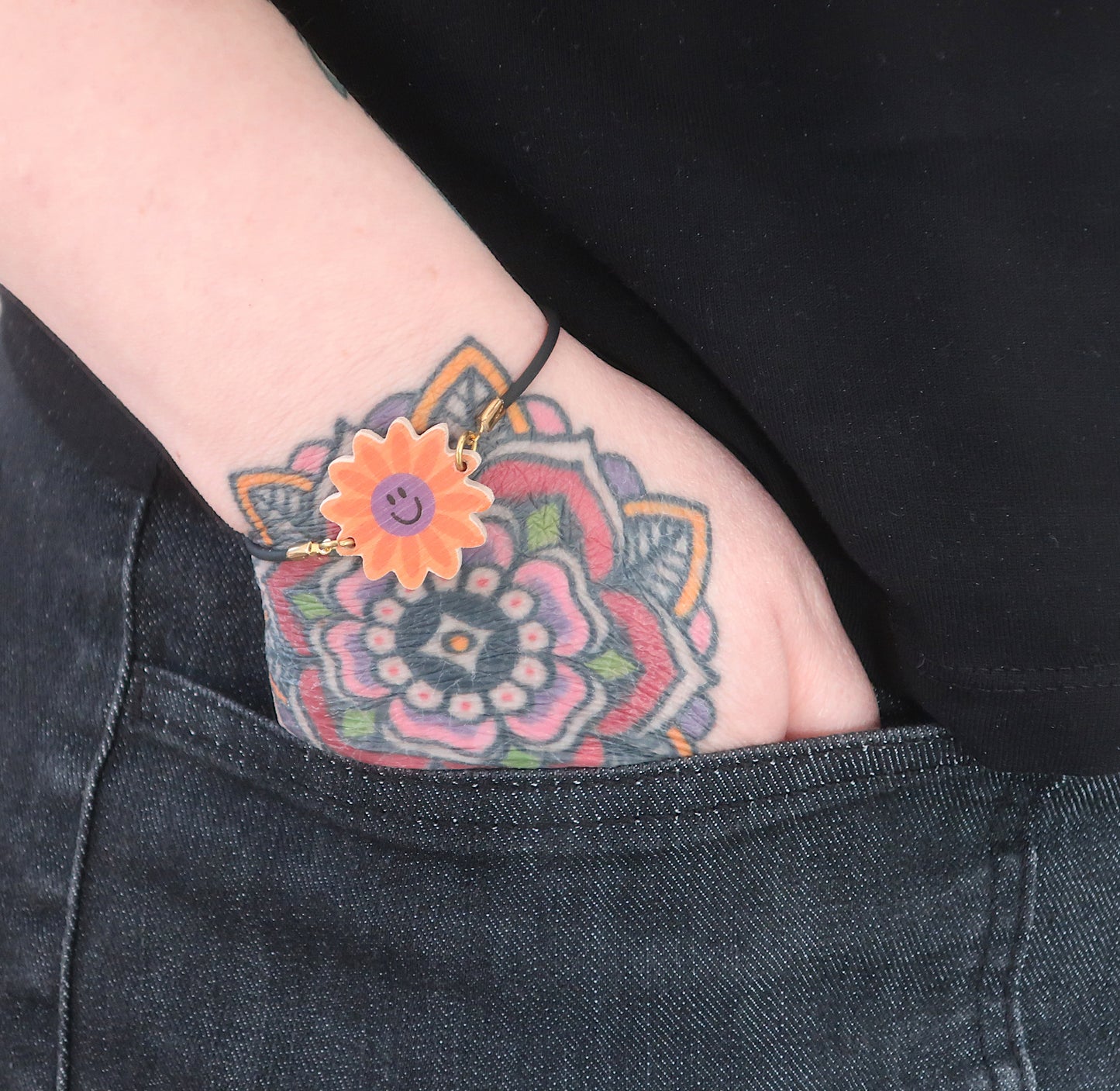 Schwarzes Kautschukarmband mit Smileyblumen-Charm